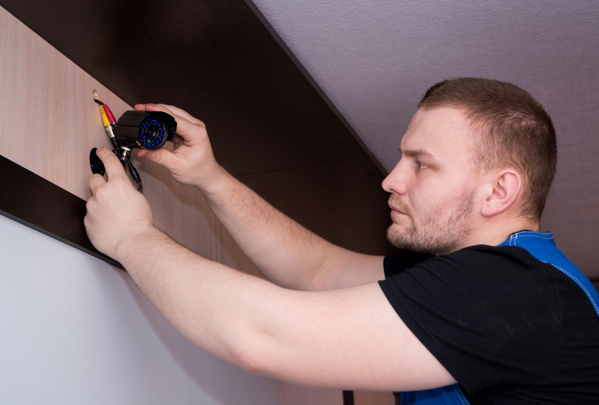 Technician installing a security camera